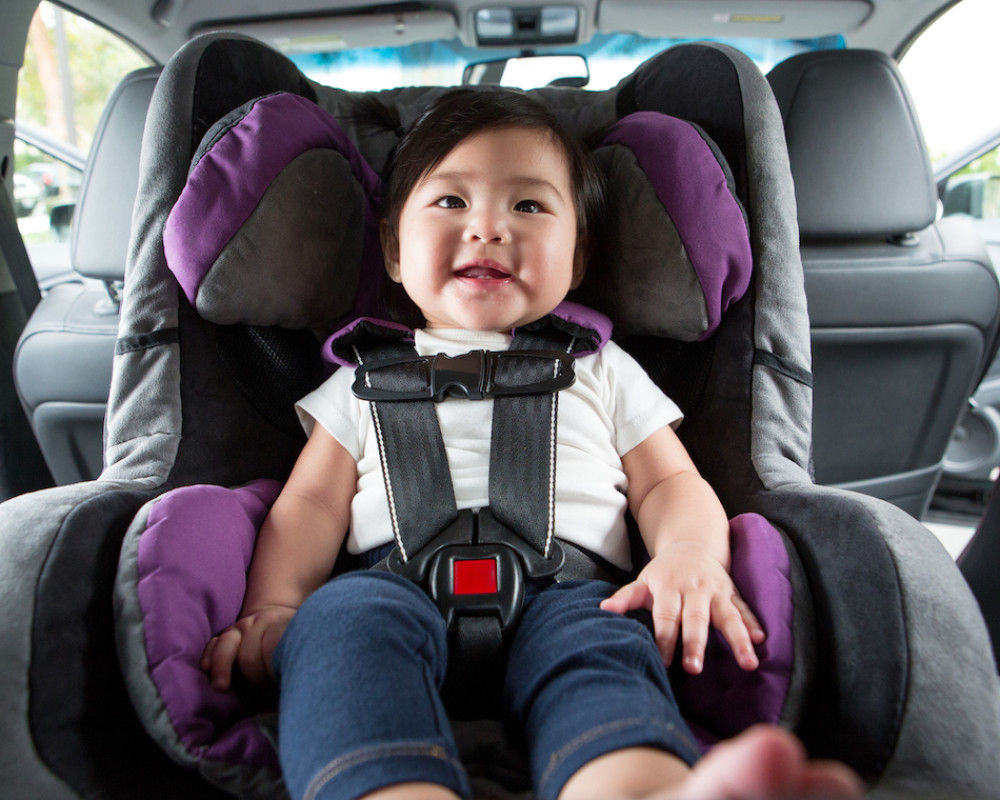 Baby buckled into auto car seat