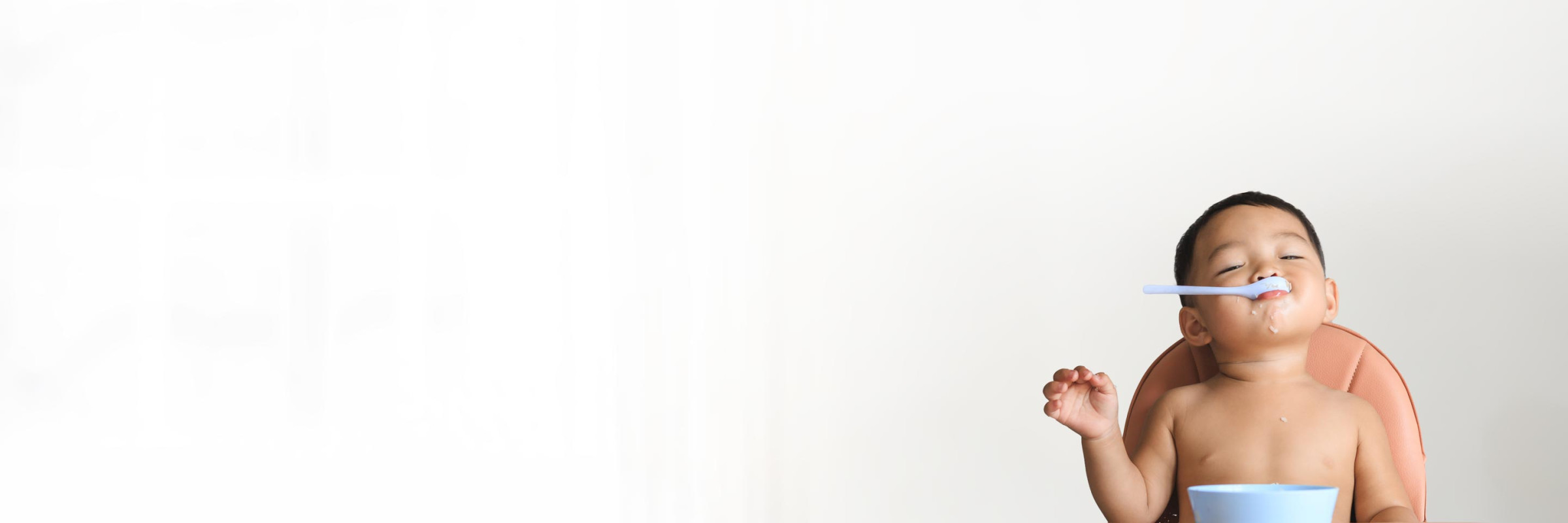 Baby playing with a plastic spoon